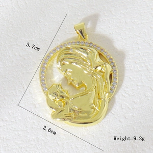 Macro detail of gold plated Mother and Child pendant with micro-pave zircon crystals
