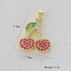 Detail view of 1.5x2.3cm cherry pendant with red and green micro-pave cubic zirconia