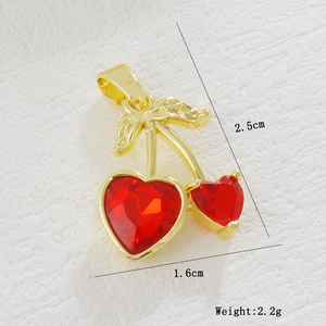 Macro detail of cherry charm showing red heart zircon stones and 2.5x1.6cm dimensions