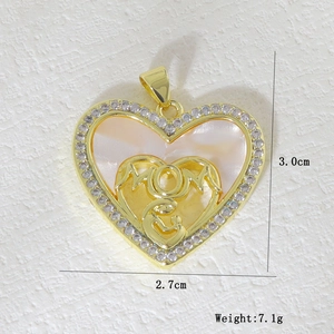 Detailed close-up of a gold heart pendant with micro-inlaid zircons and MOM design