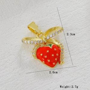 Detail of red strawberry pendant with dimensions 2.3cm by 2.0cm and gold bow detail