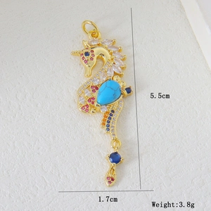 Detailed view of seahorse pendant with colorful zircons and blue turquoise stone