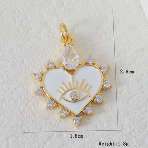 Detail view of gold evil eye heart pendant with dimensions 2.6cm and weight 1.8g
