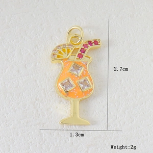 Macro view of gold cocktail cup pendant with orange enamel and colorful zircon stones