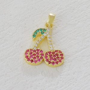 Detail of cherry pendant with micro-pave red and green cubic zirconia in gold plating