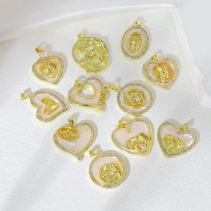 Detailed overhead view of assorted gold-plated mom and child heart pendants with zircon