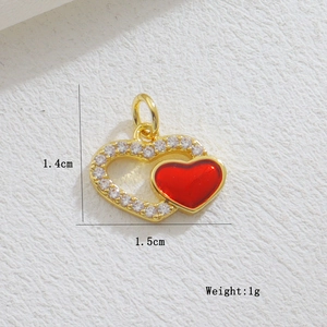 Detail showing 1.4x1.5cm gold-plated red enamel heart pendant with zircon accents