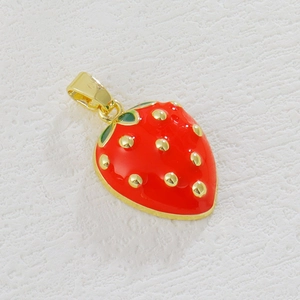 Macro detail of a 3D strawberry charm with red enamel and gold plated seed accents