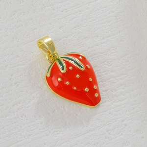 Detailed close-up of a gold-plated strawberry pendant with red enamel and green leaf