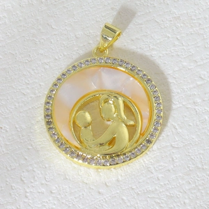 Detail of copper gold-plated pendant with white zircon and mother of pearl heart