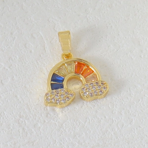 Golden rainbow pendant with colorful gemstones and white crystal clouds on white background