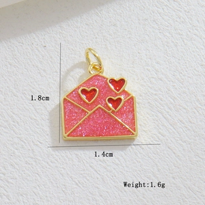 Detailed macro view of pink glitter envelope charm with red hearts and gold metal edges