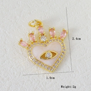 Detail of heart pendant with evil eye center and dimensions 2.4cm by 1.9cm