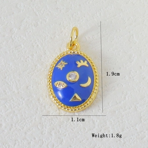 Macro shot of blue enamel oval charm with gold eye and moon details, size 1.9cm by 1.1cm