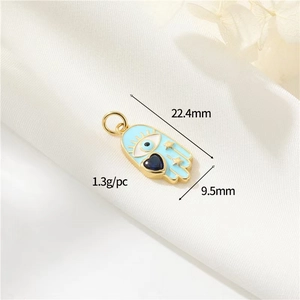 Detail of 18k gold plated Hamsa charm with blue enamel and star engraving 22.4mm