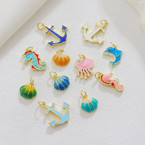 Detail of colorful marine theme DIY pendants with golden metal edges for jewelry making
