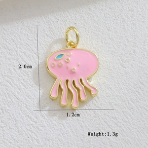 Detailed macro view of pink enamel jellyfish charm with golden tentacles for jewelry making