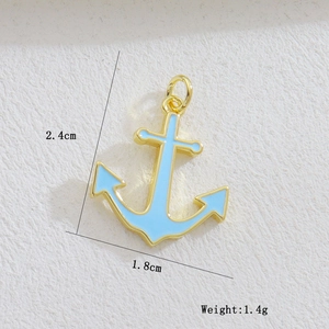 Detail view of a gold anchor pendant with blue inlay showing 2.4cm height dimensions