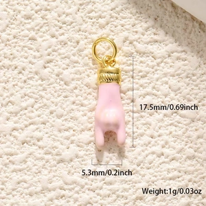 Macro view of pink rock gesture pendant with dimensions 17.5mm by 5.3mm in gold plating