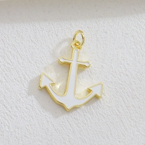 Nautical style gold-tone anchor pendant with white enamel finish and jump ring