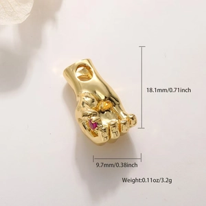 Detail of gold-plated palm charm with red stone inlay including product dimensions