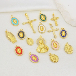 Macro view of gold cross pendants and colorful enamel religious medals on white background