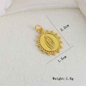 Macro shot of 2.2cm gold Virgin Mary oval pendant charm with detailed bead border