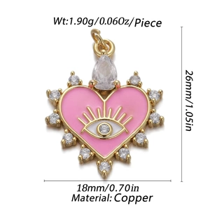Detail of pink enamel heart pendant with evil eye motif and clear zircon stones in copper