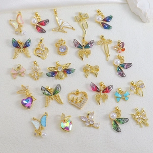 Detailed collection of gold butterfly and heart charms with colorful zircon and enamel
