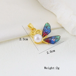 Detail view of a 2.3cm enamel butterfly pendant with pearl inlay and gold plating