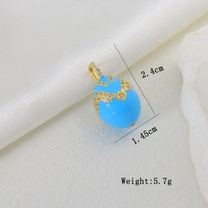 Macro detail of blue enamel egg pendant with gold filigree and white zircon micro-inlays
