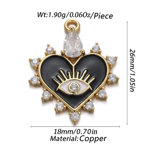 Detailed close-up of golden copper heart pendant with evil eye motif and zircon stones
