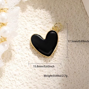 Detail view of black enamel heart pendant with dimensions 17.5mm by 15.8mm and weight