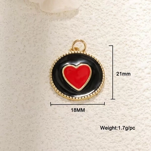 Detail of a 21mm gold beaded round pendant with black enamel and a red heart center
