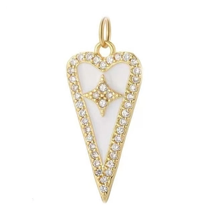 Detailed view of heart-shaped gold pendant with white enamel and sparkling star motif