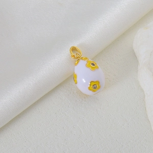 Faberge style egg pendant with white enamel floral pattern and zircon inlays