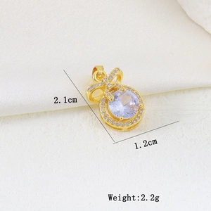 Detailed view of a gold butterfly bow pendant with large zircon stone and size measurements