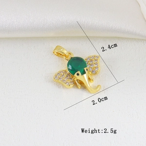 Detail view of a gold elephant pendant with a large green stone and white zircons
