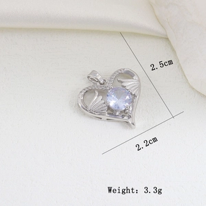 Detailed macro view of heart pendant with wings and purple stone, 2.5cm x 2.2cm