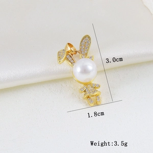 Macro detail of golden rabbit pendant with pearls and crystals showing product dimensions