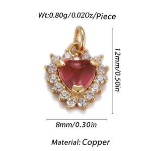 Macro shot of heart-shaped gold-plated copper pendant with red stone and pavé accents
