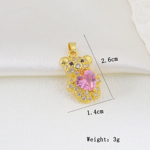 Macro shot of gold bear pendant with pink heart gemstone and zircon details, 2.6cm by 1.4cm
