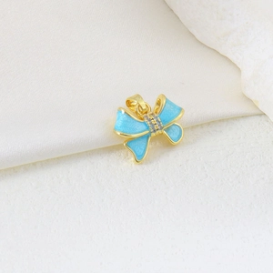 Detail of light blue butterfly pendant with gold plating and cubic zirconia inlay