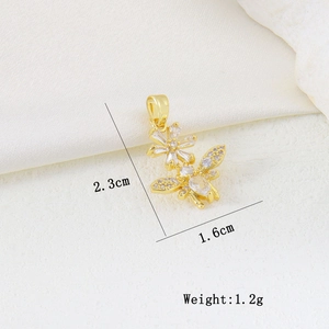 Macro detail of bee and flower pendant with white zircon stones and 2.3cm height dimension