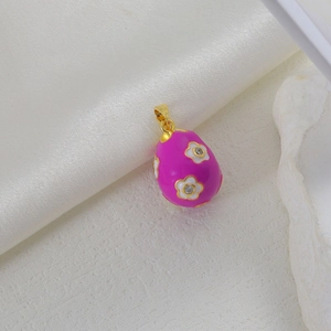 Detail of rose red enamel egg pendant with white flowers and sparkling zircons