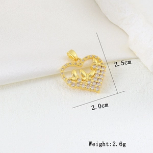 Detailed view of hollow heart pendant with gold butterflies and white cubic zirconia