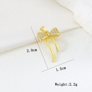 Macro view of gold butterfly bow pendant with zirconia inlays and dimensions details