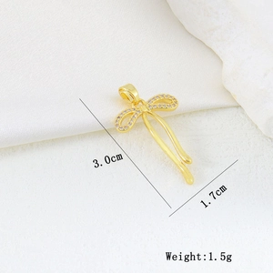 Detailed view of a gold butterfly pendant with white zircons and size measurements
