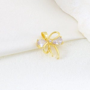 Macro shot of gold plated butterfly pendant with purple teardrop zircons on stone