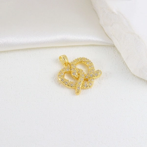 Macro detail of gold-plated double heart pendant with sparkling cubic zirconia inlay